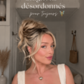 Une femme arborant un chignon décoiffé élégant dans un cadre chaleureux.