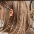 Femme avec des cheveux châtain clair, style moderne et élégant.